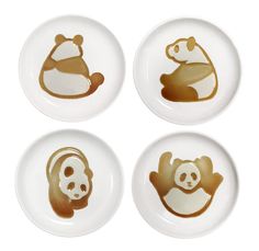 four plates with pandas on them and one is brown, the other has white