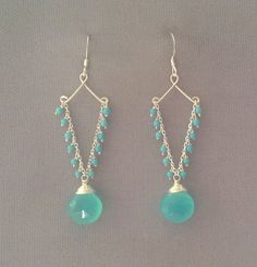 two pairs of earrings with turquoise beads and silver chain hanging from the earwires