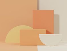 a white bowl sitting on top of a table next to some orange and pink blocks