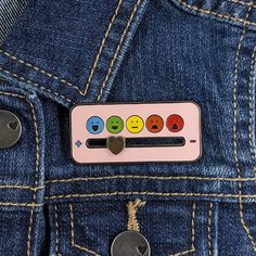 a button on the back of a pair of jeans with smiley faces painted on it