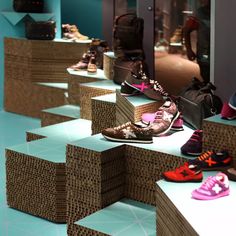 many pairs of shoes are lined up on display