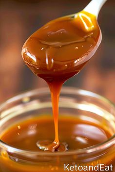 a spoon full of caramel sauce being drizzled on top of it