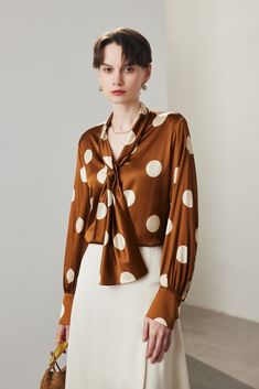 Polka Dot Charm in Luxurious Mulberry Silk Capture the essence of timeless sophistication with this vintage-inspired silk blouse. The delicate brown and white polka dot pattern exudes a classic charm, while the elegant tie at the neckline adds a touch of refined grace. This blouse's sleek tailoring ensures a smooth silhouette, making it perfect for pairing with solid pants or skirts for a poised office or casual look. Style #: WWAJ164 French Retro, Women Scarf, Silk Knit, Vintage Tie, Shearling Coat, Elegant Shirt, Natural Silk, Fur Fashion, Retro Chic