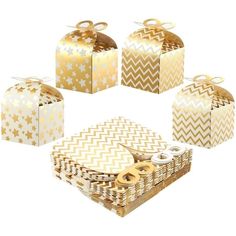 six gold and white boxes with bows on them, all lined up in a circle