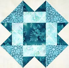 a blue and white patchwork design with flowers on it's center piece is featured in the quilter's book