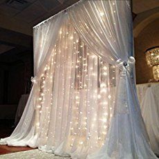 a white canopy with lights on it in the middle of a room