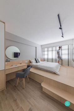 a bedroom with wooden floors and white walls