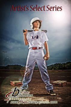 a baseball player holding a bat in front of the camera with an advertisement behind him