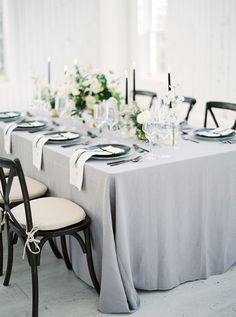 the table is set with black and white place settings