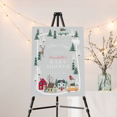 an easel with a baby shower sign on it next to a christmas tree and lights