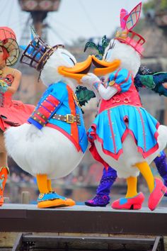 the duck dancers are dressed in colorful costumes