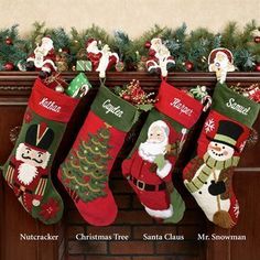 christmas stockings hanging from a mantel decorated with santa claus, snowman and other holiday decorations