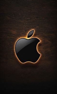 an apple logo is shown on a wooden surface with light coming from the top and bottom