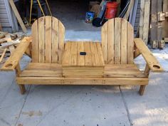 a wooden bench sitting in the middle of a yard