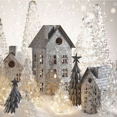 a christmas scene with houses and trees in the snow