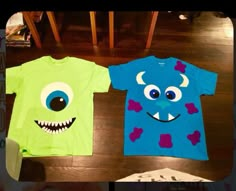 two children's t - shirts with monster faces on them sitting on the floor