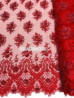 red sequin lace fabric with floral design on the bottom, and an intricate pattern on the side