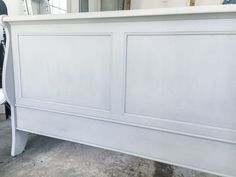 a white bed frame with two doors on each side