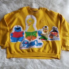 Vintage Reworked 80s Sesame Street Fabric Hand Sewn On An Oversized Vintage Starter 90s Heavyweight Pro80 Xl Solid Yellow Sweatshirt Appreciate Measurements Pit To Pit : 27" Length: 28" Smoke Free Big Bird, Cookie Monster, Bert Ernie, Grover Reading Alphabet Theme Fabric All Reworked Items Are Sold As Is And Price Is Firm Wash Inside Out And Hang Or Lay Flat To Dry Vintage Crew Neck Sweatshirt With Patchwork, Vintage Crew Neck Patchwork Sweatshirt, Vintage Patchwork Tops For Streetwear, Vintage Crew Neck Patchwork Tops, Vintage Patchwork Crew Neck Top, Vintage Patchwork Sweatshirt, Bert Ernie, Boring Outfits, Fringe Sweatshirt