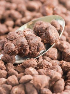 a spoon filled with chocolate balls on top of a pile of brownie batters