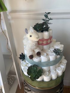 a diaper cake made to look like a sheep with succulents on it