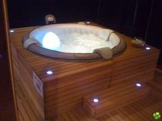 a hot tub with lights around it in a room