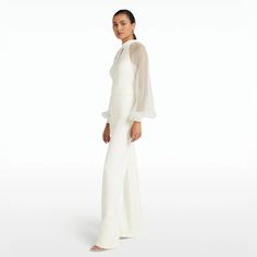 Safiyaa Danna Ivory Jumpsuit Regular Price 1,095 Crew Neck, Loop-Hole, Long Sleeve Jumpsuit With Wide Leg In Ivory. Fits True To Size. Model Is 175cm | 5'9'' And Wearing A Fr36 Heavy Crepe: 92 % Polyester 8 % Elastane Soft Organza: 100% Silk Dry Clean Only Size 8 Available Brand New, Never Worn. For More Information, Dm. Shop Now! White Floor-length Evening Set, Elegant White Long Sleeve Jumpsuit, White Long Sleeve Jumpsuits And Rompers For Evening, White Long Sleeve Jumpsuits For Evening, Elegant Jumpsuit With Sheer Long Sleeves, Chic Fitted Floor-length Set, White Long Sleeve Pantsuit For Party, Chic Long Sleeve Jumpsuits And Rompers For Wedding, Fitted Long Sleeve Jumpsuits And Rompers For Wedding