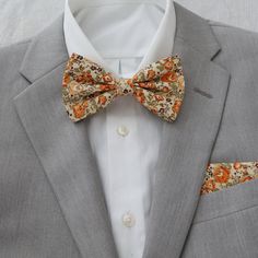 Darwin Marigold Yellow Floral Collection includes the following:  adult necktie and bow tie with matching pocket squares.                                              FREE swatches of this collection is available upon request.                                                                                          Color:  Marigold Material:  Cotton                                                                                                                         Adult Skinny Necktie:  approx Gold Bow Tie For Business, Classic Gold Bow Tie For Groom, Gold Classic Bow Tie For Groom, Gold Dapper Ties For Weddings, Formal Orange Bow Tie, Fitted Bow Tie For Father's Day, Fitted Bow Tie For Groom, Marigold Wedding, Mens Wear Wedding