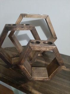 three wooden hexagonals sitting on top of a table