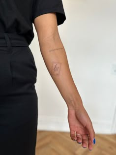 a woman with a small tattoo on her arm