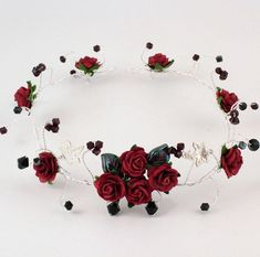 a tiara with red roses and black beads