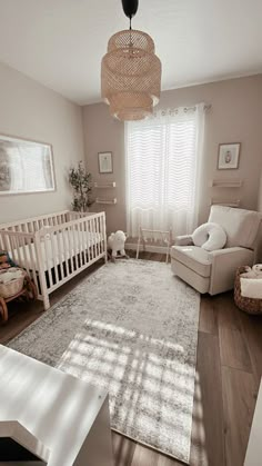 a baby's room with a crib, rocking chair and large rug on the floor