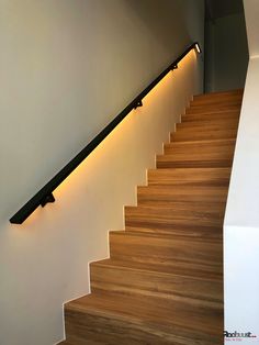 a wooden stair case with lights on it