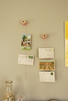 there are pictures on the wall and post it notes attached to the wall with magnets