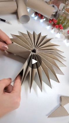 someone is making a paper star decoration