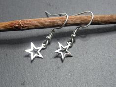 Sterling silver Star earrings dangle, dainty Star celestial earrings sterling silver Christmas gifts for her, cute minimalist earrings. Perfect and stylish for any occasion and would make a lovely Christmas or birthday gift for your loved one!  MATERIAL  Sterling silver ear wire Sterling silver star 9.5mm in width Inclusions: 1 pair of earrings 1 pair of rubber backs 1 organza bag Gift-wrapped in an eco-friendly packaging FREE personalised message on the packaging PLEASE NOTE that due to the nat Minimalist Star Charm Dangle Jewelry, Minimalist Nickel-free Star-shaped Jewelry, Minimalist Nickel-free Star Shaped Jewelry, Minimalist Nickel-free Star Jewelry, Minimalist Star-shaped Nickel-free Jewelry, Minimalist Star-shaped Hypoallergenic Jewelry, Adjustable Star Charm Earrings For Gift, Minimalist Star Charm Earrings As Gift, Minimalist Star-shaped Jewelry With Ear Wire