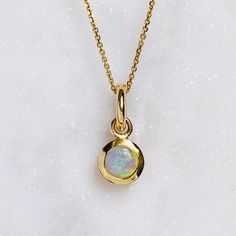 A crystal opal has been set into a gold bezel. Opal measures approx. 5mm round. Weight without chain approx. 1.3g. Trace chain measures 45cm. Pictured with a polished finish. For a matte finish, please leave a note at checkout. Please note, we will match the opal as close to the image as possible. Each opal is unique and may vary in appearance and colour from what is depicted on the site. Opal Necklace Silver, Necklace Stack, Crystal Opal, Solid Gold Jewelry, Opal Crystal, Opal Necklace, Chain Pendants, Solid Gold, Gold Jewelry