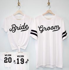 two bride and groom shirts hanging on a wall