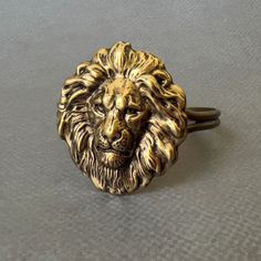 Lion's Head Cuff...  I attached a LARGE antiqued brass plated brass lion's head stamping to the top of a silver plated cuff bracelet.  The large lion head stamping comes from very old tooling! This lion head cuff is adjustable.  Women - fits medium to large size wrist  Men - fits small to medium size wrist You will receive this fabulous lion's head cuff gift wrapped!  A perfect gift for someone with a Leo birthday! Nature inspired necklaces are listed here! https://www.etsy.com/shop/DaysLongGone Lion Oc, Lion Jewellery, Birthday Nature, Largest Lion, Cowardly Lion, Leo Birthday, Lion's Mane, Cosplay Jewelry, Lion Mane