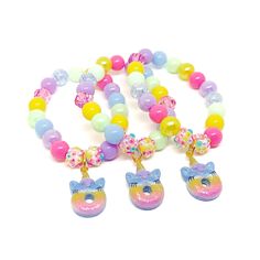 These adorable stretchy bracelets are the perfect favor for your little one's unicorn donut themed party! Each bracelet features a glittery rainbow unicorn donut charm, resin rhinestone beads and an assortment of pink, purple, blue, green and yellow 10mm acrylic beads strung with durable stretch floss cord. Each bracelet will arrive individually packaged in organza bags. Select the size and number of bracelets needed from the drop down menus. Please message me if you have any questions or if you Donut Themed Party, Unicorn Donut, Girl Rainbow, Pink Purple Blue, Rainbow Birthday, Stretchy Bracelets, Comfy Sweaters, Rainbow Unicorn, Rhinestone Bead