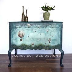 an old dresser has hot air balloons painted on it