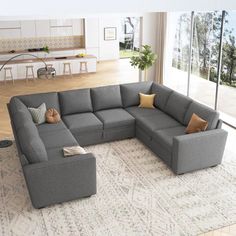 a large gray sectional couch sitting on top of a rug