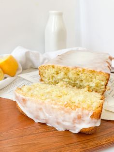 a loaf of lemon pound cake sitting on top of a wooden cutting board