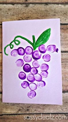 an art project with grapes painted on paper