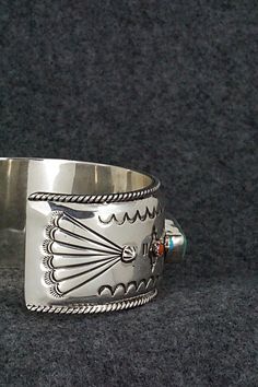 This stunning and substantial turquoise, coral and sterling silver bracelet was made by Navajo silversmith Emerson Delgarito. The inside is signed E. Delgarito and stamped sterling.Size: 5 3/8" (will fit up to a 6 1/2" wrist)Gap: 1 1/8"Length: 1 1/8"Free shipping on all orders! We ship with USPS and always include tracking. All orders ship within a day of payment.Returns are accepted up to 30 days after you receive your order. Just send us a message. Our shop offers cash back or store credit. Th Southwestern Silver Multi-stone Bracelets, Southwestern Silver Multi-stone Bracelet, Artisan Silver Multi-stone Cuff Bracelet, Southwestern Silver Bracelet With Multi-stone, Silver Artisan Multi-stone Cuff Bracelet, Southwestern Sterling Silver Inlay Bracelet Gift, Native Jewelry, Metal Work, Coral Turquoise