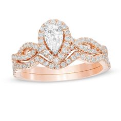 Celebrate your love with this elegant diamond bridal set. Created in 14K rose gold, the exquisite engagement ring showcases a 1/3 ct. pear-shaped diamond wrapped in a shimmering diamond halo. The twist ribbons of the split shank sparkle with diamonds. On your wedding day, seal your vows with the contoured diamond-lined band. Captivating with 1 ct. t.w. of diamonds and a bright polished shine, this bridal set glistens with all your beautiful memories. Due to the nature of pre-owned jewellery, the Pear Shaped Diamond Engagement Rings, Twisted Ribbons, Diamond Frame, Pear Engagement Ring, Diamond Bridal Sets, Beautiful Memories, Split Shank, Pear Shaped Diamond, Bridal Set