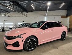 a pink car is parked in a garage