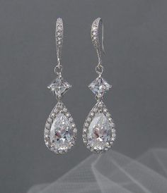 Hollywood elegance! These crystal earrings are simple and elegant, yet make a bold statement! The sterling silver ear wires are accented with Cheap Sparkling Crystal Wedding Earrings, Silver Delicate Chandelier Earrings For Party, Pierced Chandelier Earrings For Wedding, Elegant Pierced Chandelier Earrings For Wedding, Wedding Dangle Bridal Earrings, Sterling Silver Drop Earrings For Wedding, Wedding Bridal Drop Earrings, Silver Long Drop Wedding Earrings, Elegant Pierced Bridal Earrings For Wedding