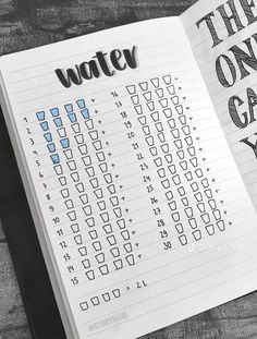 a notebook with the words water on it and an open one - day planner next to it