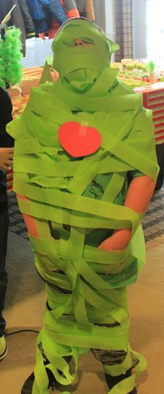 a man in a costume made out of green paper